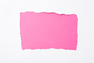 pink colorful background in white torn paper hole