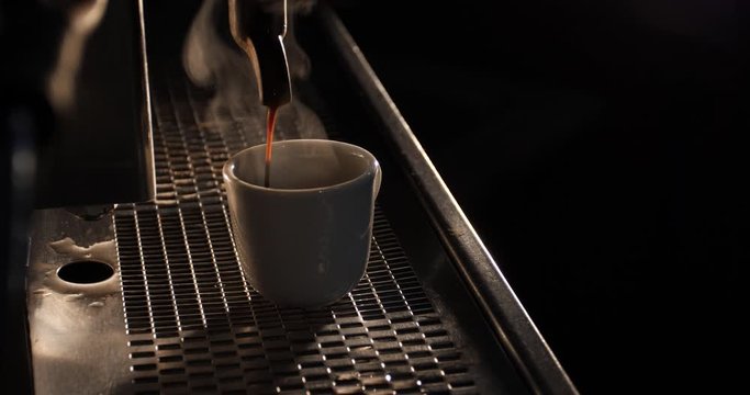 white cup of aromatic espresso made on vintage coffee machine