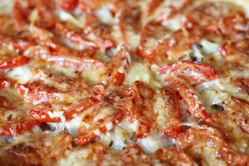 Pizza background, freshly baked pie with cheese, meat and tomatoes closeup