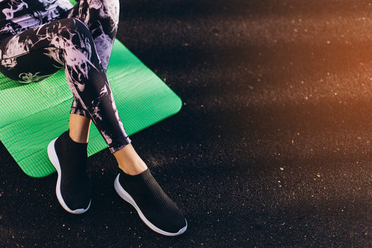 Legs of sporty girl training outdoors, workout, exercise concept. Young blondie beauty sexy fitness caucasian girl outdoors with sport equipment. Healthy active lifestyle concept - Powered by Adobe