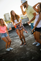 Group of carefree friends dancing have fun in summer