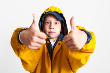 Builder thumb up. The kid is dressed as a builder. Future profession. Career guidance. Happy successful builder. Career. Business in the construction industry. The property. Child game.