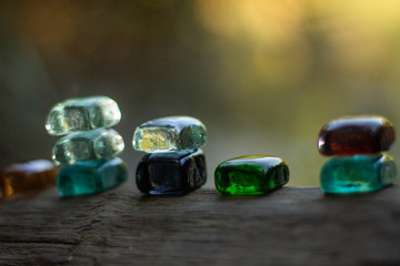 color transparent stones, items on a log, nature background, place for text	