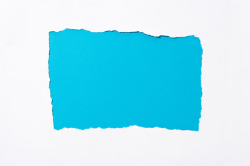 blue colorful background in white torn paper hole