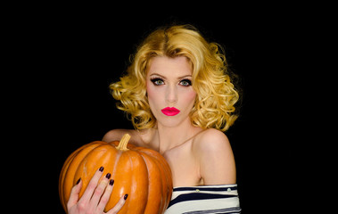 31 october. Halloween. Serious blonde girl with pumpkin. Trick or treating. Halloween party. Happy Halloween. Sexy woman in witch halloween costume. 31 October. Holidays, decoration and party concept.