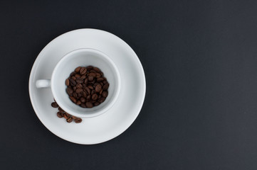Obraz na płótnie Canvas White cup of coffee and coffee beans isolated on black background