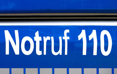 Polizei sign on a German police car. Notruf 110- Emergency call 110