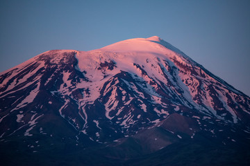 Fototapeta premium Breathtaking sunset on Mount Ararat, Agri Dagi, the highest mountain in the extreme east of Turkey accepted in Christianity as the resting place of Noah's Ark, snow-capped and dormant compound volcano