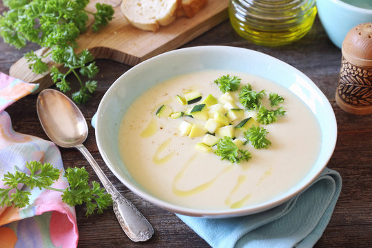 Zucchini vegetable cream soup, parsley and olive oil dressing