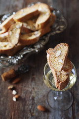 Italian cookies: almond cantuccini and glass of white wine