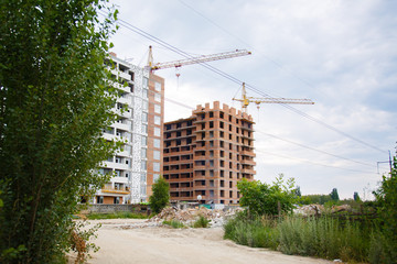 Construction of new house or building. General view. Unfinished cement building in the summer. The...