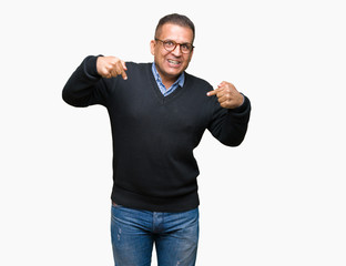 Middle age bussines arab man wearing glasses over isolated background looking confident with smile on face, pointing oneself with fingers proud and happy.