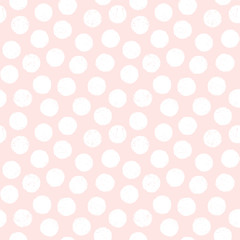 Seamless pastel background with polka dots in blush pink and white. Cute minimal pattern with textured overlay for baby, girls, gift wrapping paper, textiles, wallpaper.