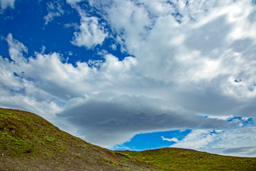 Beautiful clouds over the hilly landscapes of Iceland.
