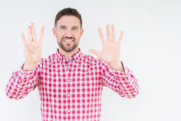 Naklejka premium Young handsome man wearing shirt over isolated background showing and pointing up with fingers number nine while smiling confident and happy.