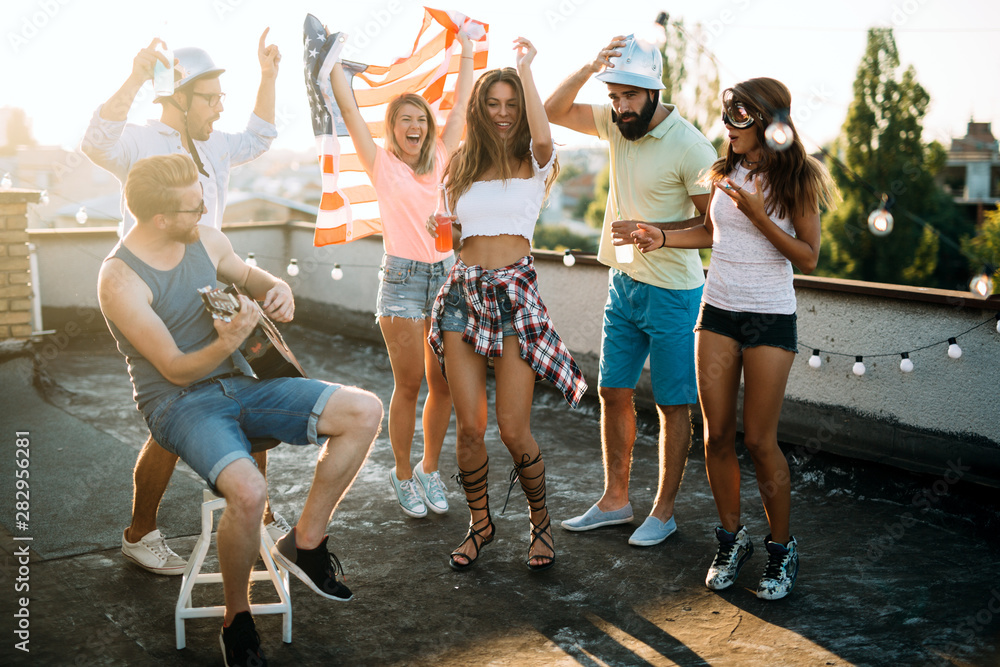 Wall mural Happy group of young friends having fun in summer