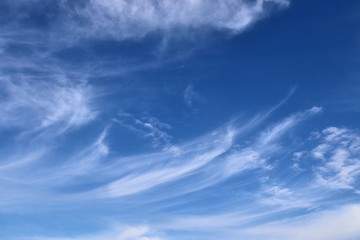 Beautiful white cirrus cloud formations on a deep blue sky