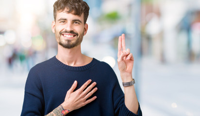 Young handsome man over isolated background Swearing with hand on chest and fingers, making a...