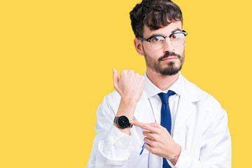 Young professional scientist man wearing white coat over isolated background In hurry pointing to...