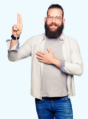 Young blond man wearing glasses Swearing with hand on chest and fingers, making a loyalty promise...