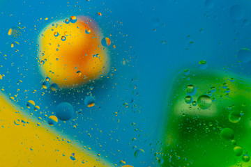 Micro molecular abstract pattern of colored oil bubbles on water. 
