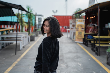 Portrait of asian young woman smiling look happy walking on the way