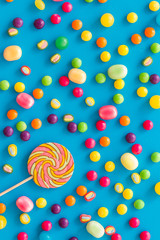 Candy dots, lollipop for blog design on blue background top view pattern