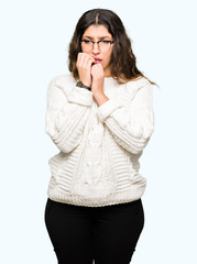 Young beautiful woman wearing glasses looking stressed and nervous with hands on mouth biting nails. Anxiety problem.