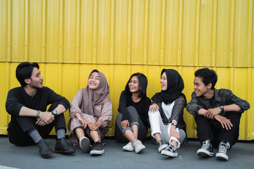 Group of young people hanging out at the rooftop building