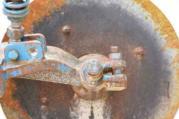 Old rusty nuts and bolt joint on fragment of partially old machine	
