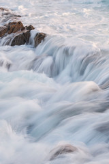 Water flow motion over rocks during big swell in Australia
