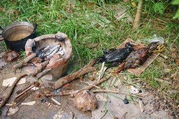 Grill chicken on burned red hot charcoal over Asian stove