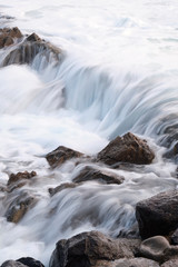 Water flow motion over rocks during big swell in Australia
