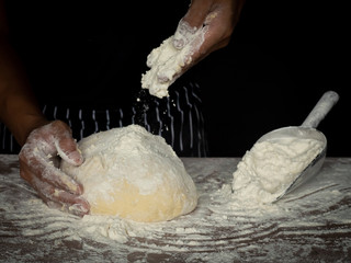 Cook is creating a dough to make bread.