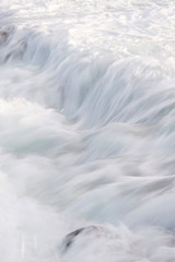 Water flow motion over rocks during big swell in Australia