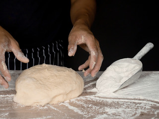 Cook is creating a dough to make bread.