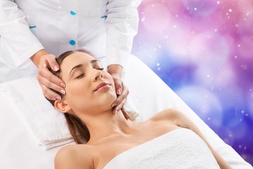 Obraz na płótnie Canvas Beautiful young woman enjoying head massage in spa center