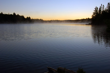 Sunrise and mist in beautiful lake in Algonquin Park