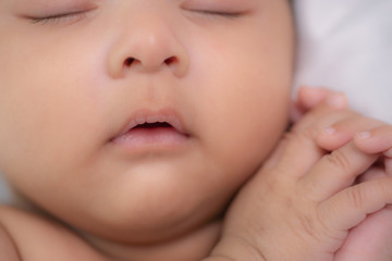 portrait of cute asian infant baby boy sleeping