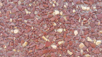 the surface structure is created by spraying, sifted sand, purple and cream small stones, building facades