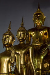 Golden Buddha statues inside Asian temple