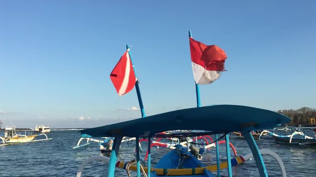 Indonesian national flag fly on Traditional Indonesian fishing boat in Padang Bai  Bali, Indonesia.