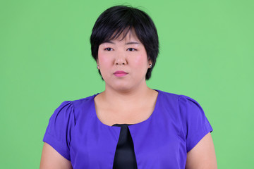 Face of young beautiful overweight Asian woman thinking