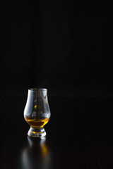 A pour of whiskey in a glencairn glass.