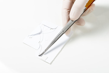 Doctor holding needle holder. Removing Suture Thread Packing. Nylon surgical thread.