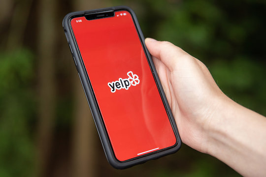 General view of the Yelp app opening on iPhone XS Max in Everett, Washington on August 8, 2019