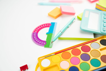 School supplies. Set of colorful school accessories isolated on the white table.