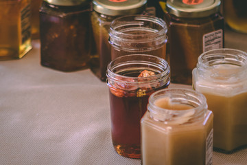 A selection of honey products on a table forsale