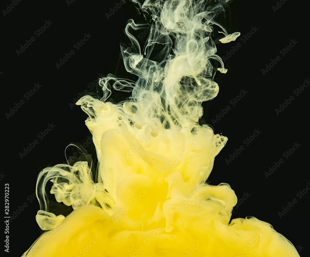 Poster yellow-white acrylic cloud dissolving into water, isolated on black background, close up view. ink m