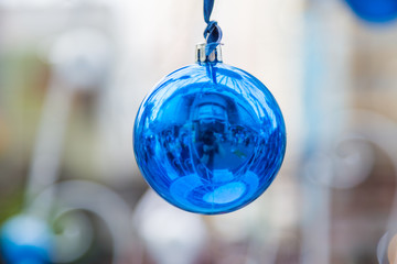 Christmas balls hanging on ribbon with bokeh